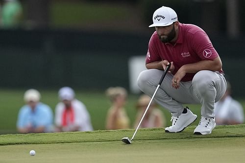 Jon Rahm lines up a putt on the eighth green during the third round of the Tour Championship