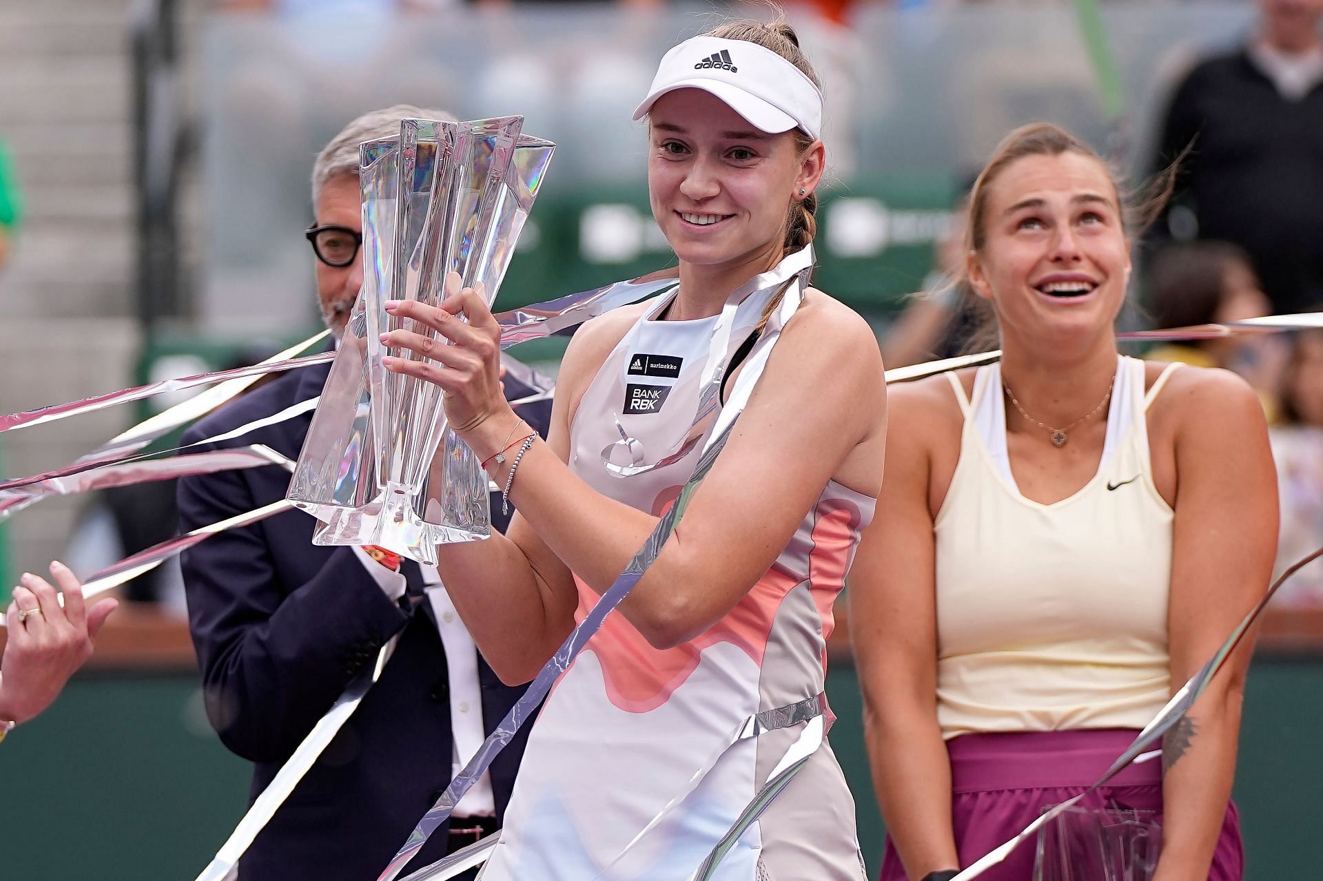 Elena Rybakina poses (L) with the WTA 1000 title in Indian Wells