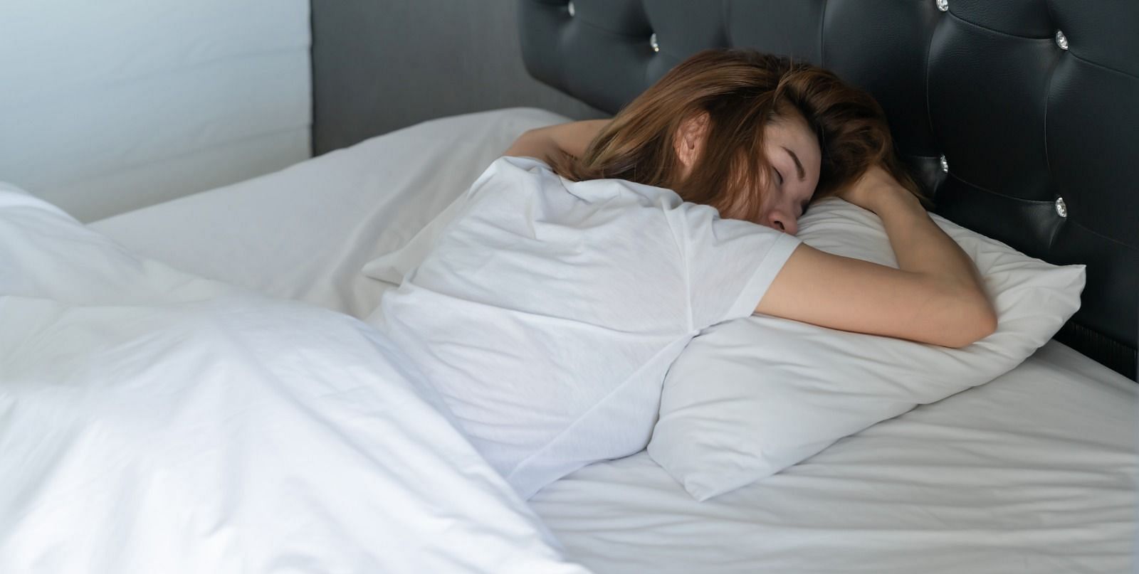 Sleeping on your stomach (Image via Getty Images)