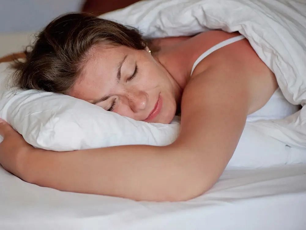 Sleeping on your stomach (Image via Getty Images)