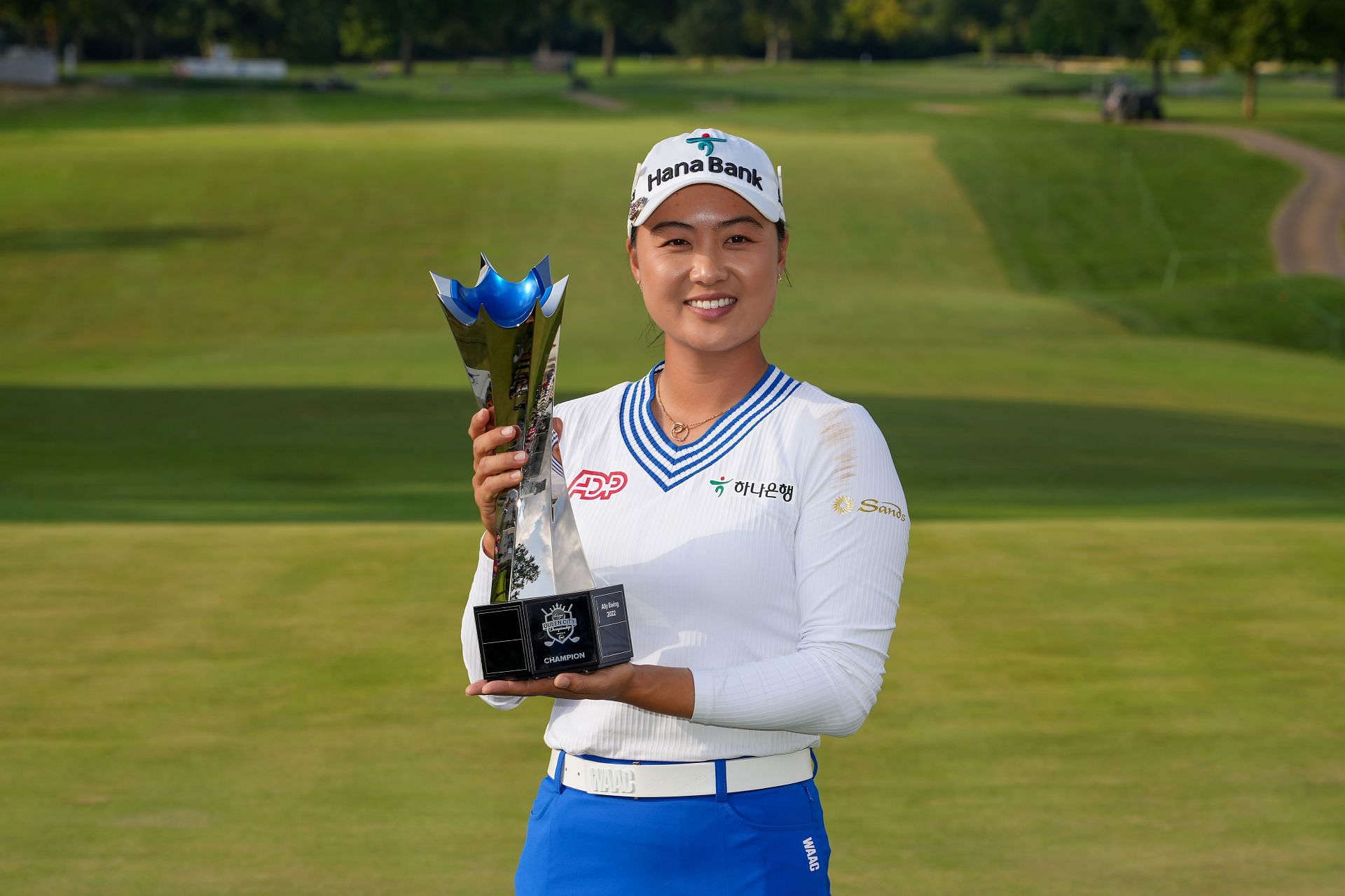 Minjee Lee celebrates with the trophy after winning the Kroger Queen City Championship