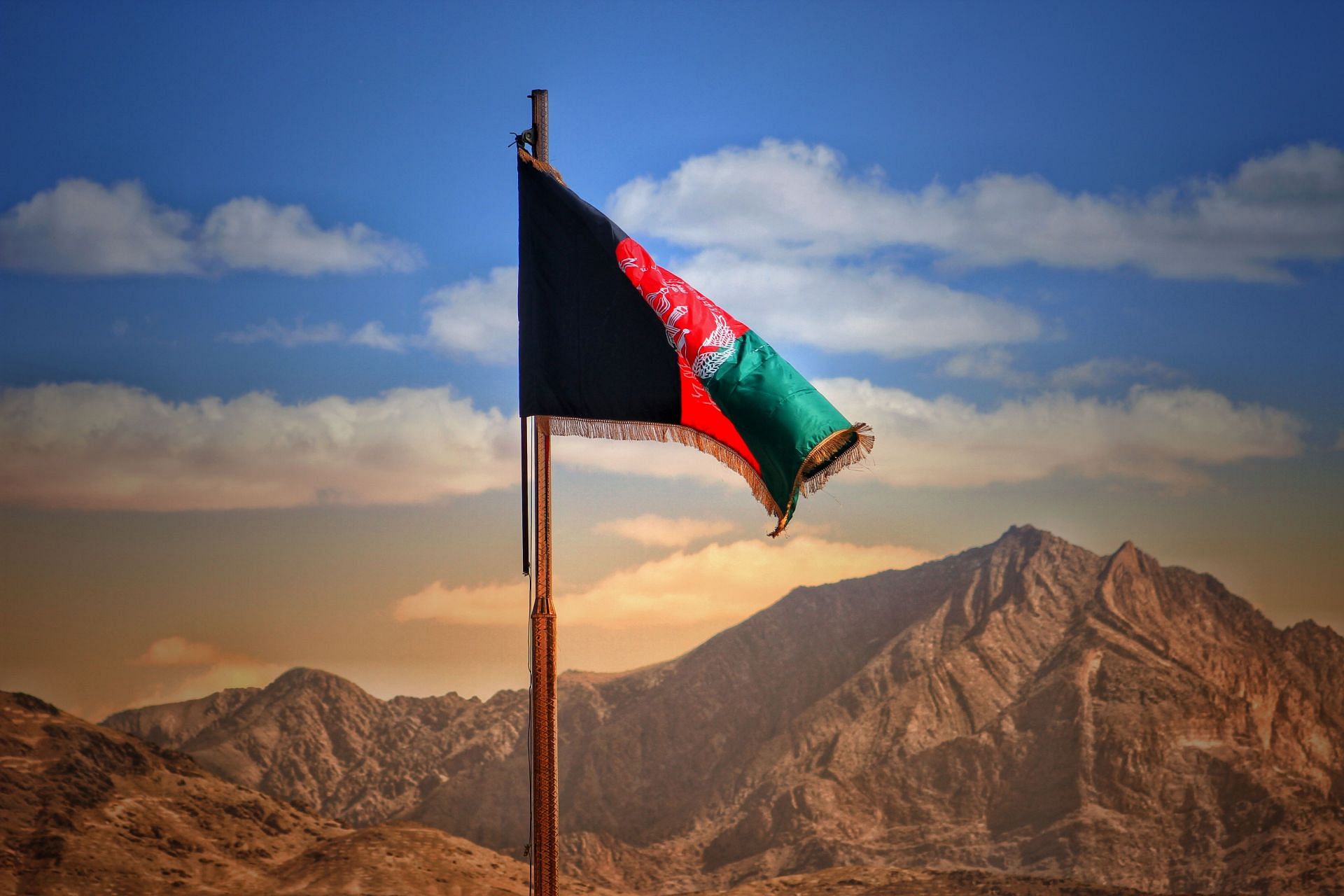 Three-colored national flag of Afghanistan (Image via Unsplash)
