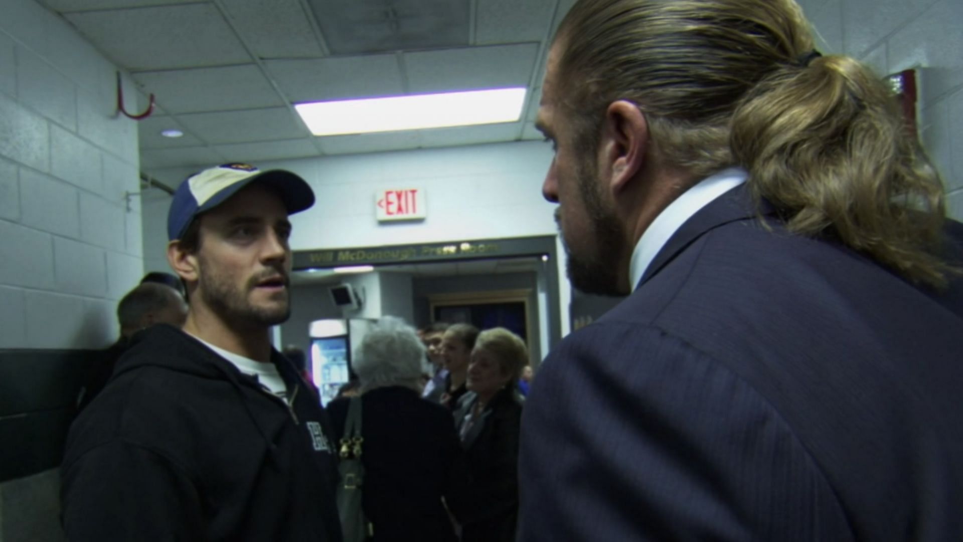 CM Punk (left) and Triple H (right)
