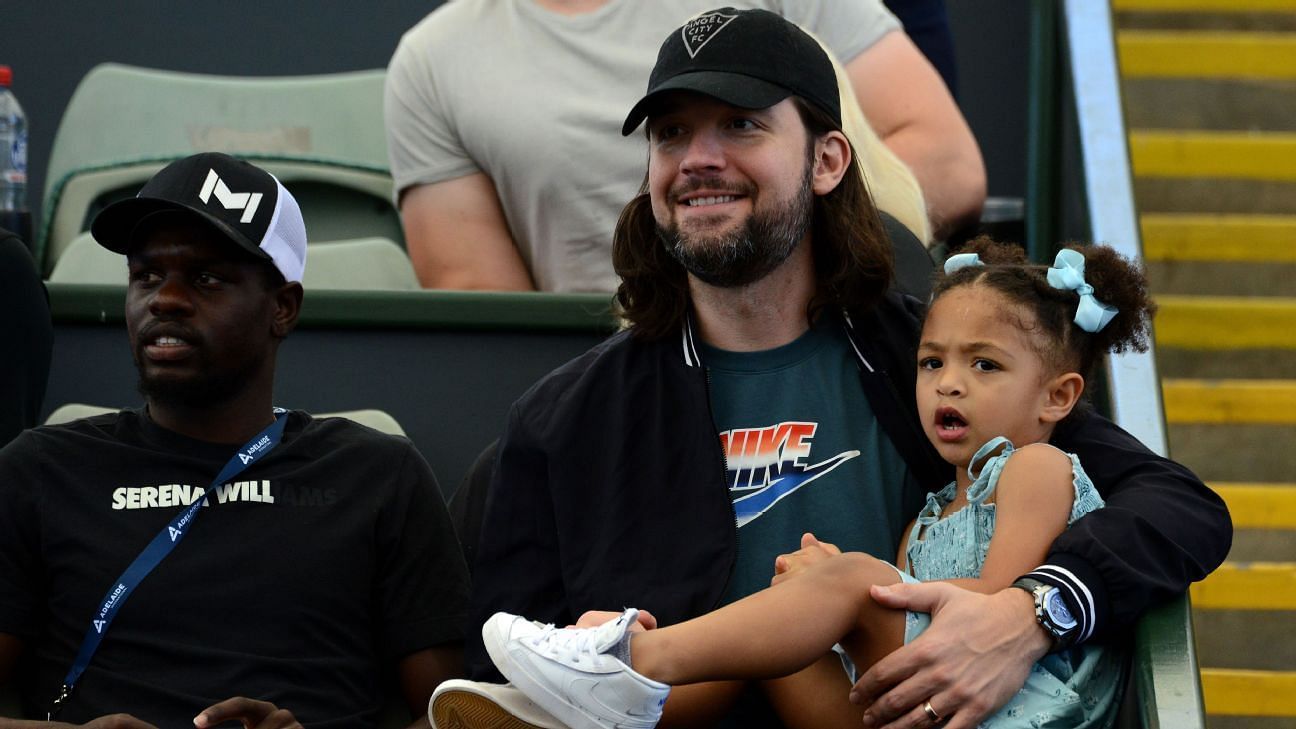 Alexis Ohanian and daughter Olympia watch an NWSL match