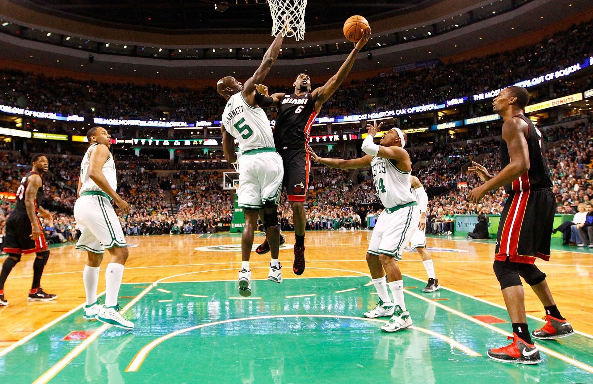 LeBron James drives to the hoop against Kevin Garnett in an NBA game.