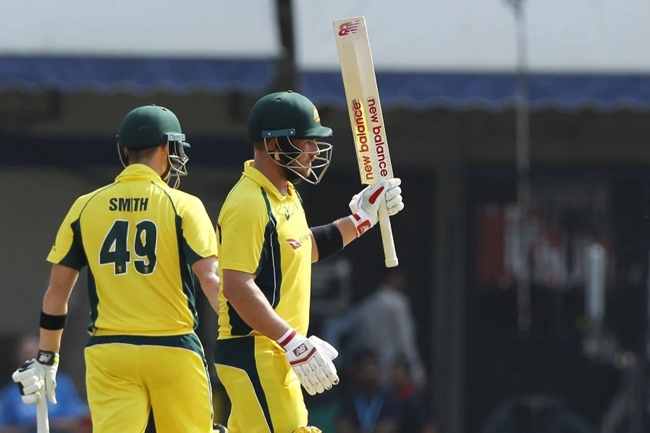 Aaron Finch raises his bat after a milestone [Getty Images]