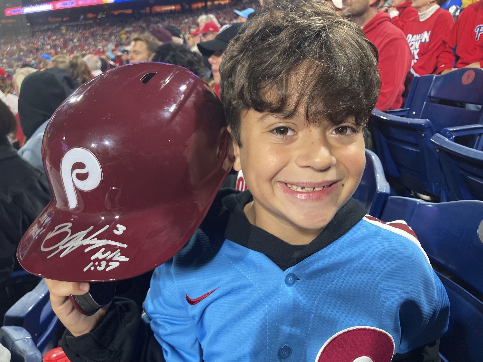 With the help of security guards, Bryce Harper signed the helmet with a personal message for Hayden.
