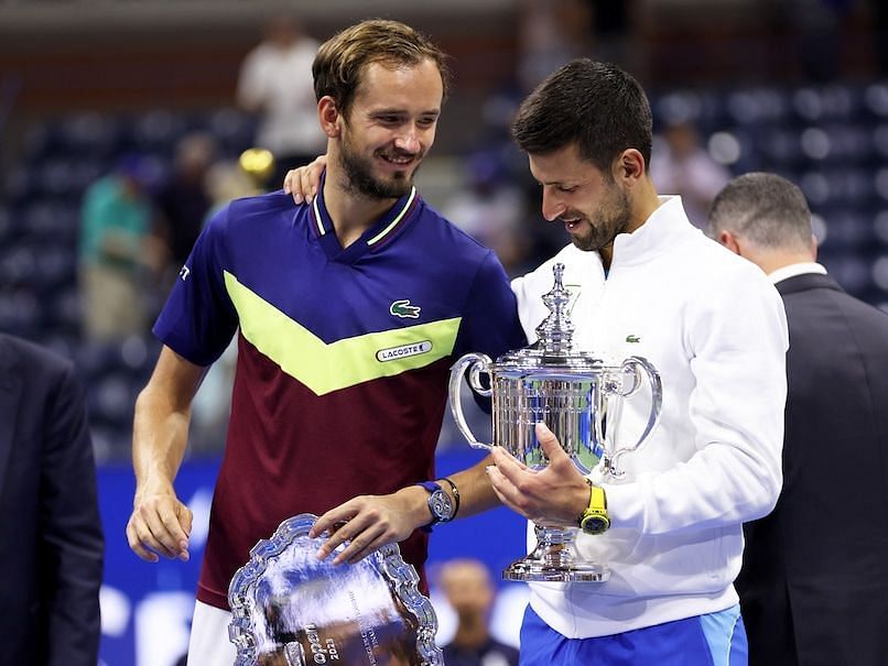 Novak Djokovic and Daniil Medvedev embrace during the 2023 US Open trophy ceremony