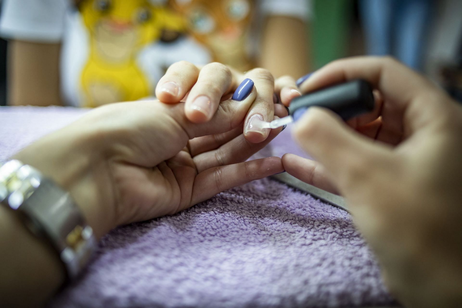 How to get nail glue off skin (Image via Getty Image/ Milan Markovic)