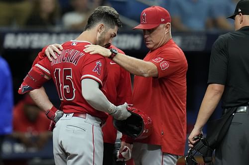 Manager Phil Nevin and Randal Grichuk look at Grichuk's helmet during a game in St. Petersburg, Fla.