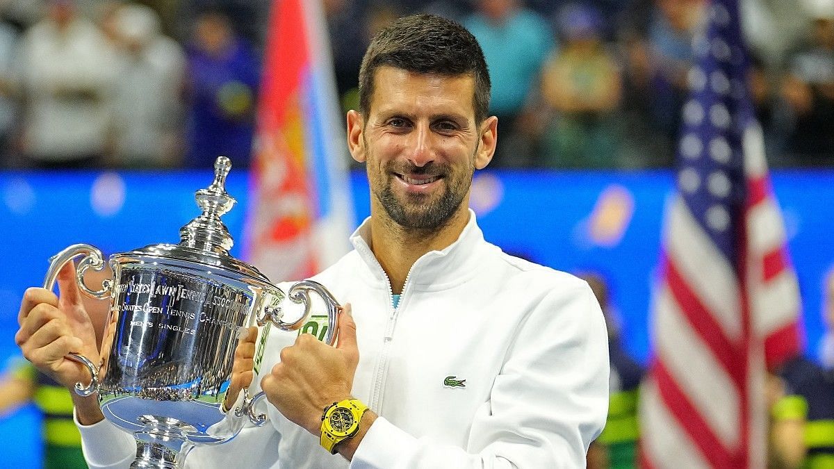 Novak Djokovic poses with the 2023 US Open title in New York