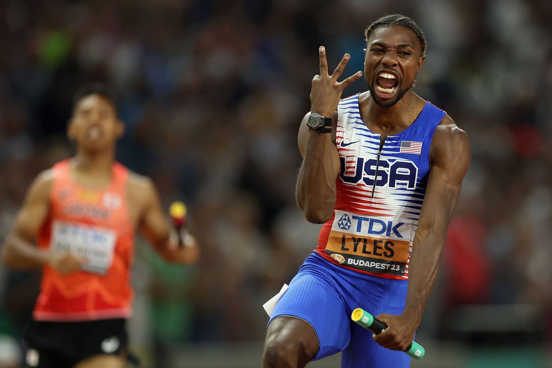 Noah Lyles celebrates after winning his third gold medal in the men's 4x100m at the 2023 World Athletics Championships in Budapest, Hungary