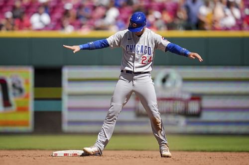 Chicago Cubs' Cody Bellinger gestures after stealing second base against the Cincinnati Reds