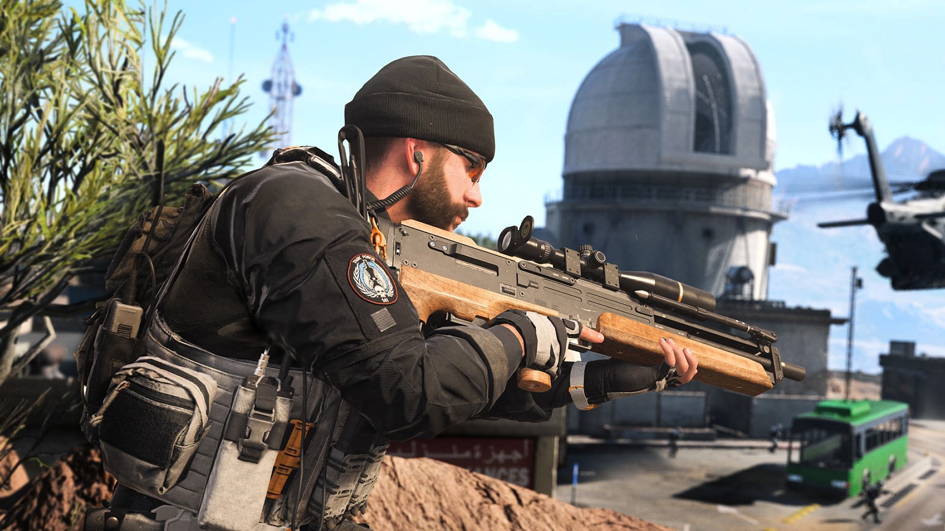 Operator Captain Price holding a Sniper Rifle with the Zaya Observatory in the background.