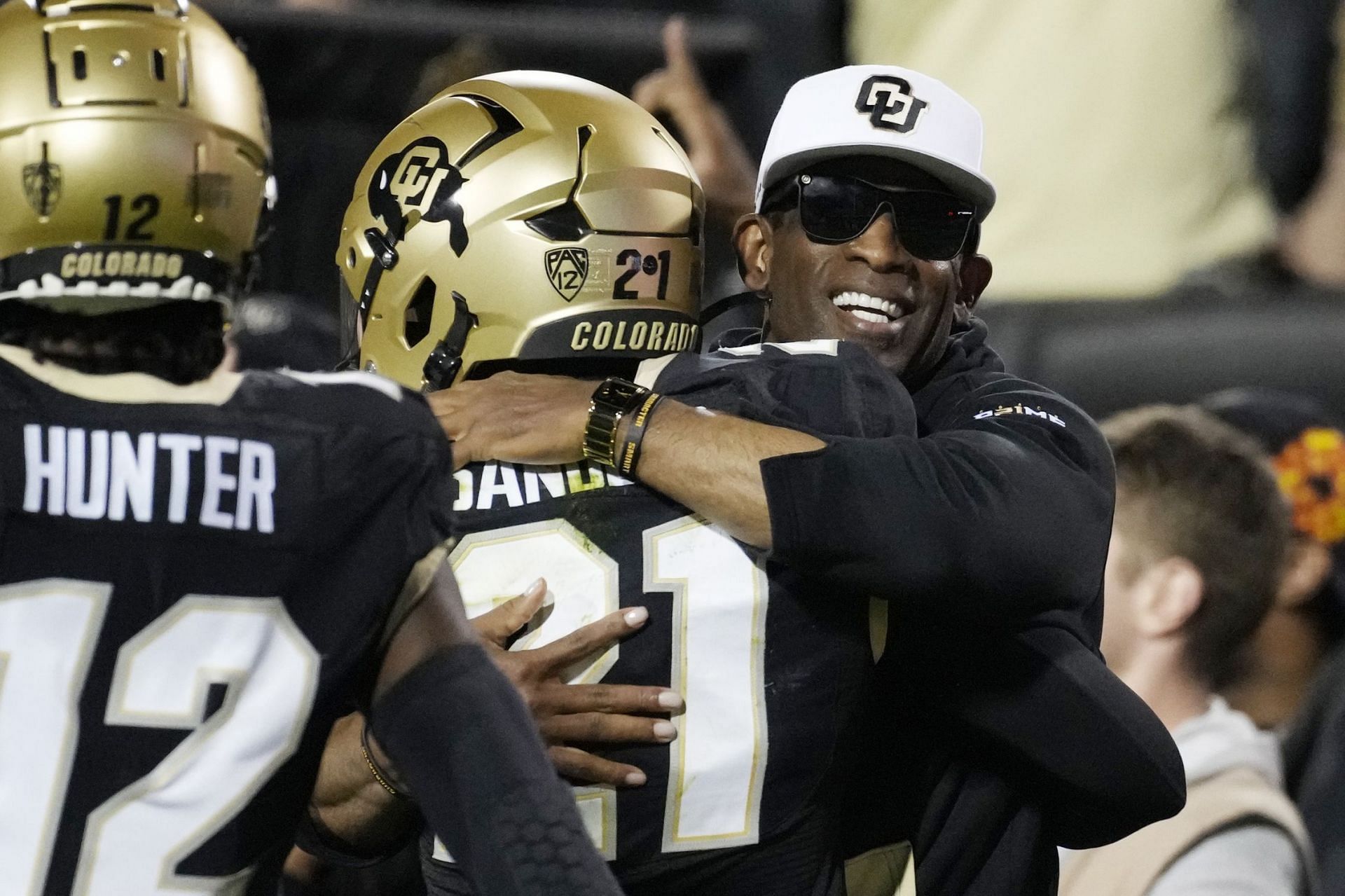 Colorado St Colorado Football: Colorado head coach, right, hugs his son, safety Shilo Sanders, after he returned an interception for a touchdown in the first half of an NCAA college football game against Colorado State Saturday, Sept. 16, 2023, in Boulder, Colo. (AP Photo/David Zalubowski)
