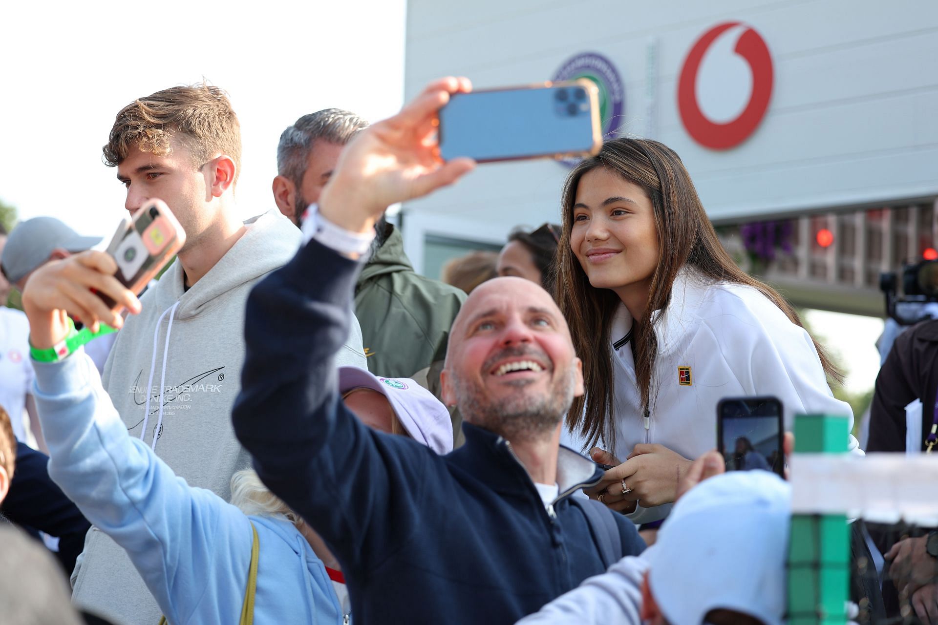 Emma Raducanu poses with fans at the 2023 Wimbledon Championships