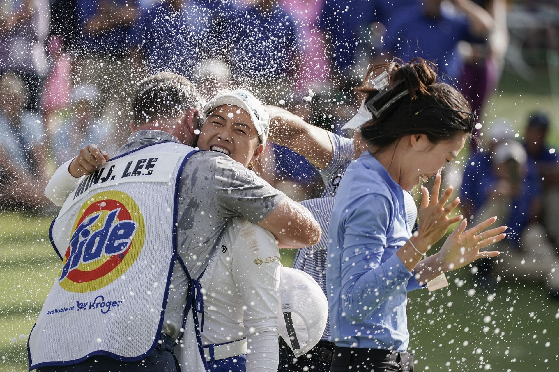 Minjee Lee is doused with champagne along with her caddie after winning the 2023 LPGA Kroger Queen City Championship