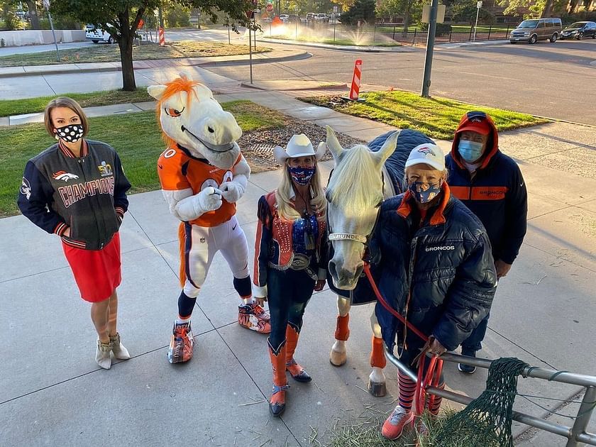 Denver Broncos Bucking Thunder Mascot With Football Player 