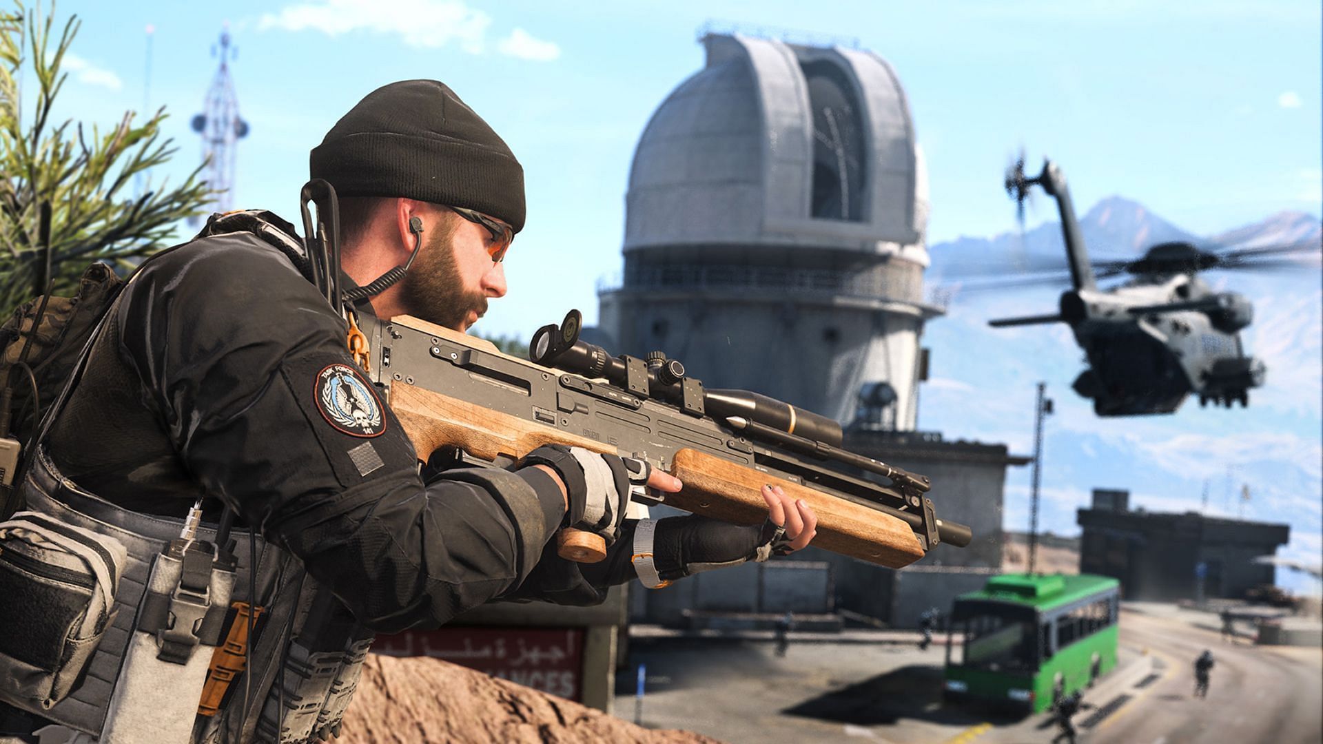 Captain Price holding a Sniper Rifle as a Helicopter flies by him.