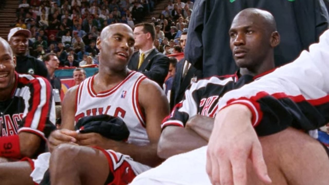 Scott Burrell [L] and Michael Jordan on the Chicago Bulls bench during the 1997-98 season