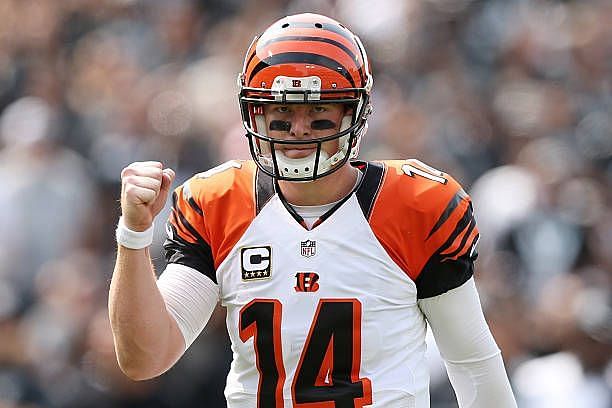 Andy Dalton of the Cincinnati Bengals celebrates after a touchdown against the Oakland Raiders during the first half of their NFL game at O.co...