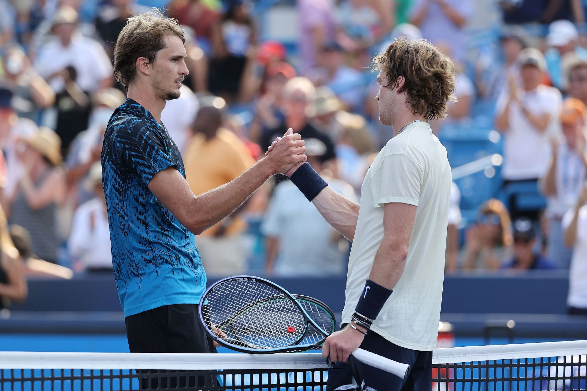 Alexander Zverev and Andrey Rublev greet each other.