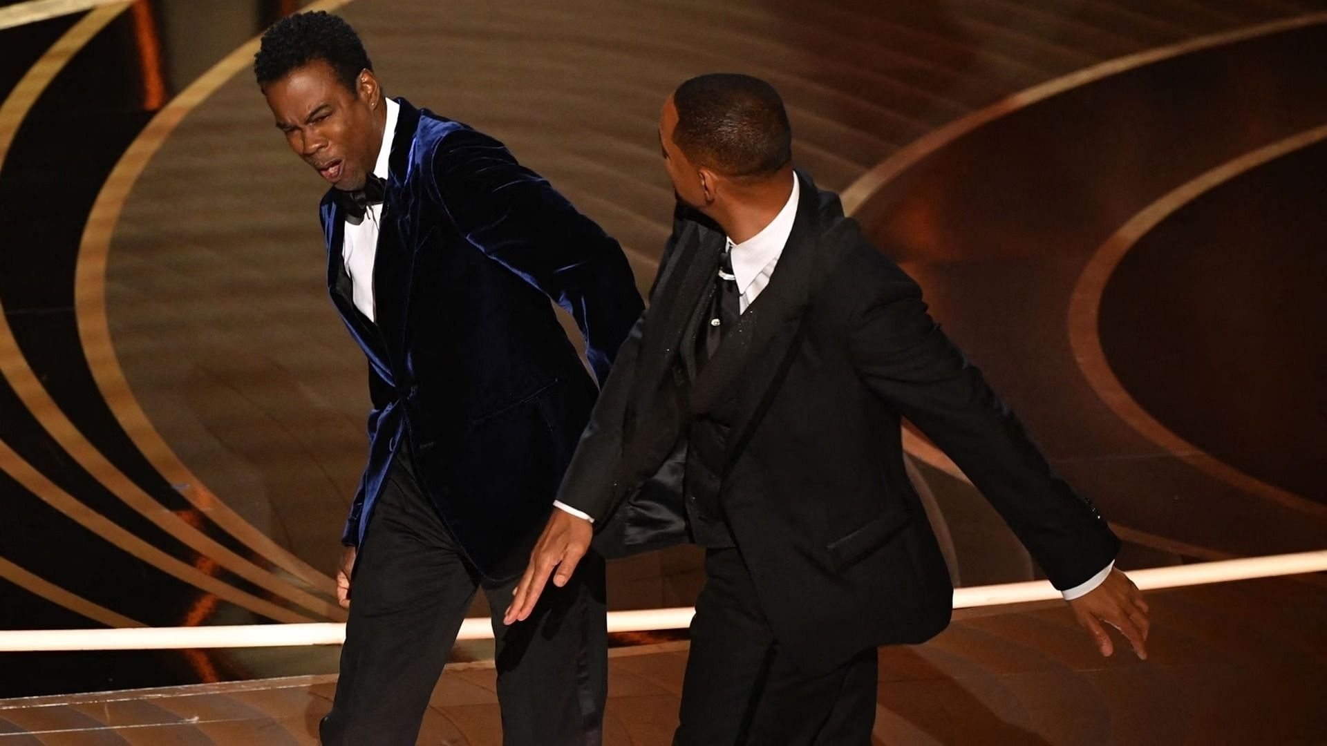 Will Smith slaps Chris Rock onstage during the 94th Oscars (Image via Robyn Beck for AFP)