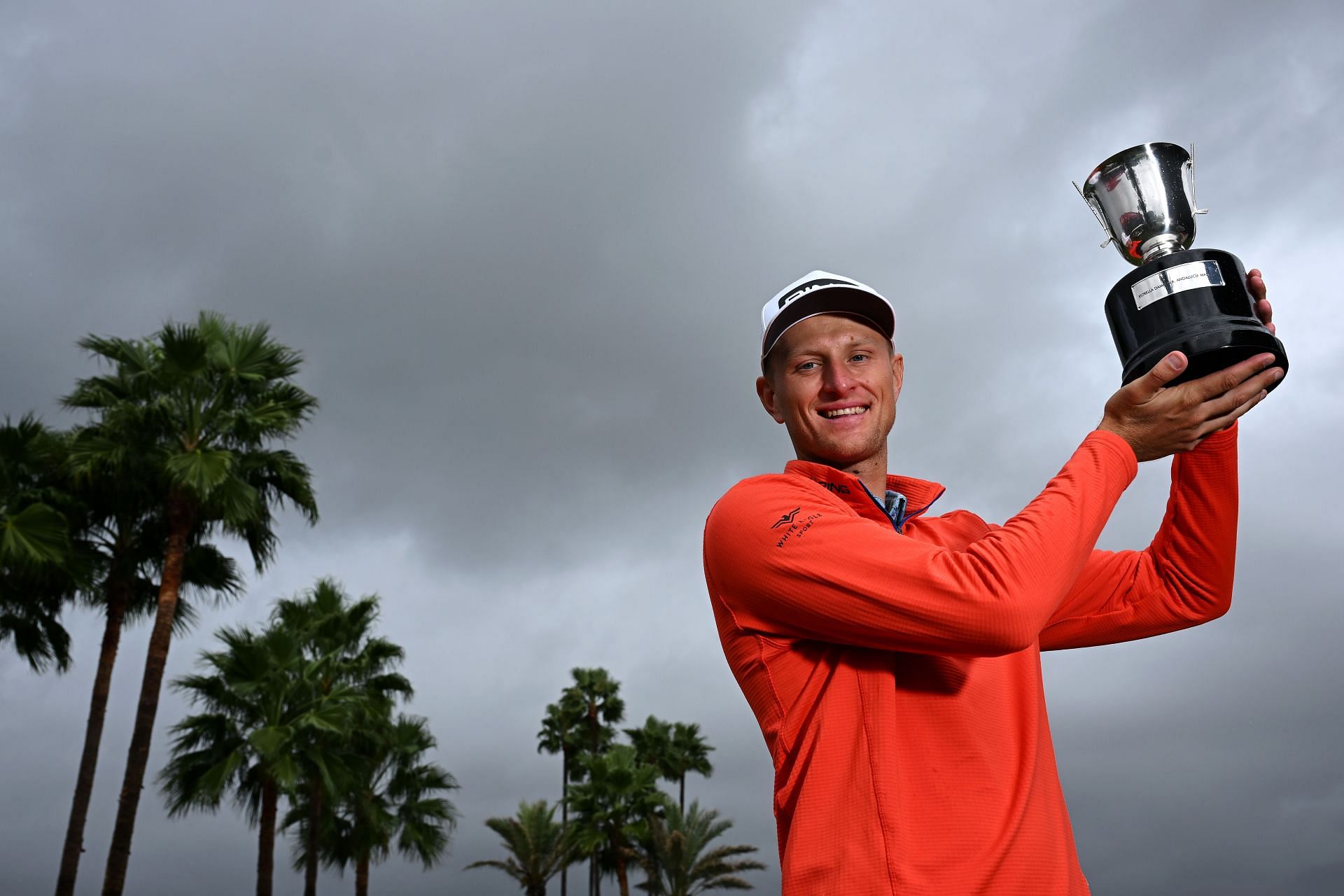 Adrian Meronk of Poland celebrates with the trophy after winning the Estrella Damm N.A. Andaluc&iacute;a Masters (Image via Getty)