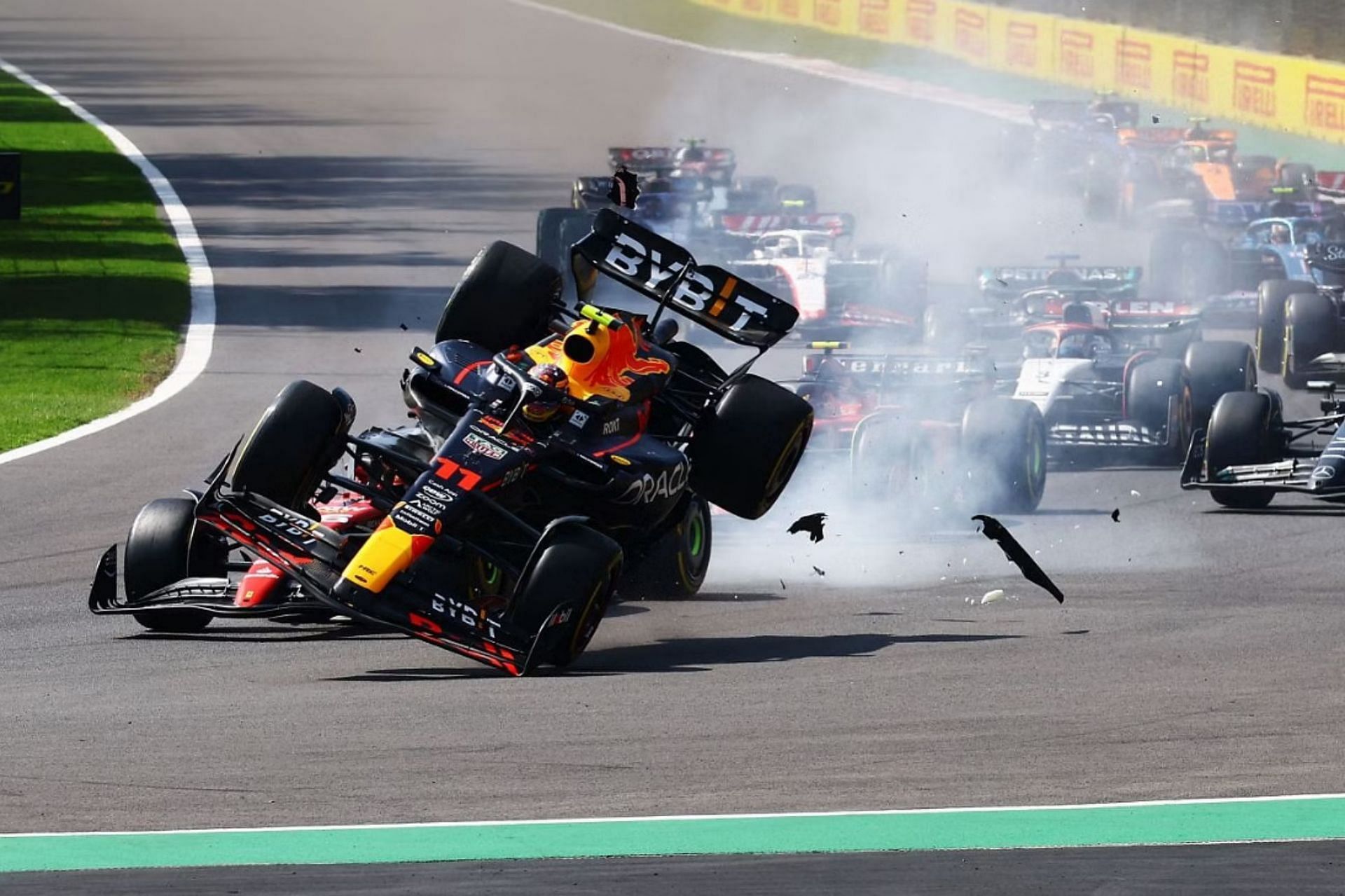 Sergio Perez (11) collides with Charles Leclerc (16) into the first corner at the start of the 2023 F1 Mexican Grand Prix. (Photo by Mark Thompson/Getty Images)