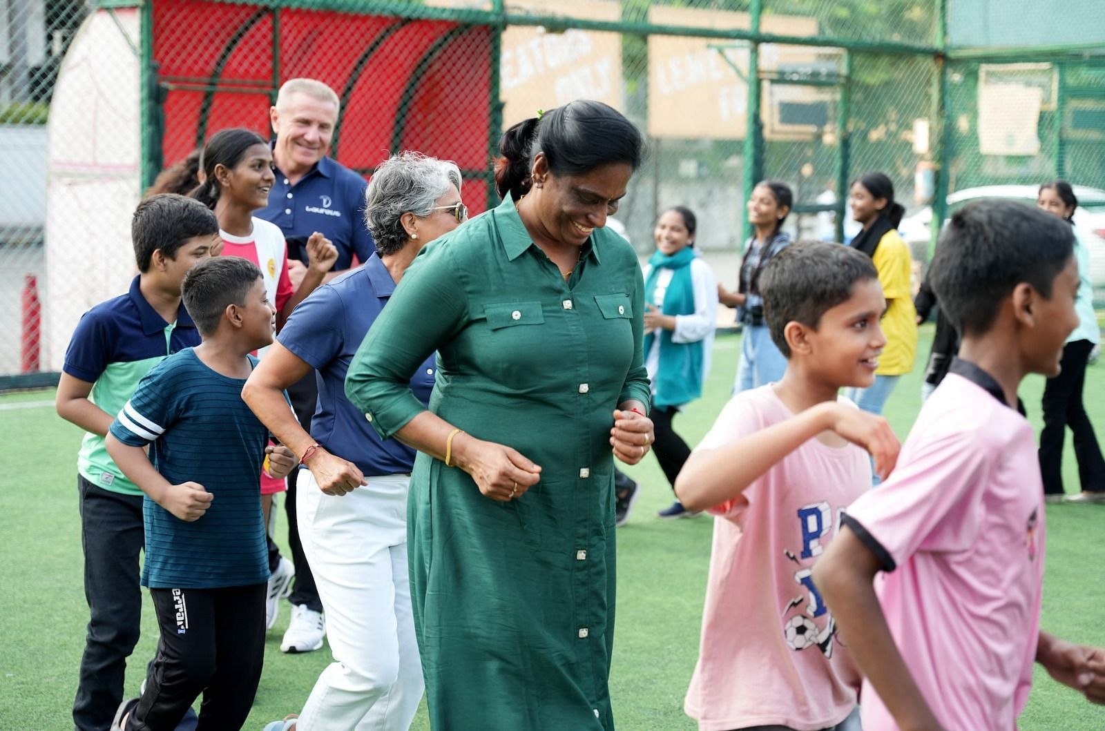 El Moutawakel and PT Usha engaging with the children