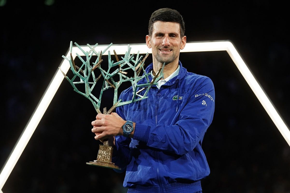 Novak Djokovic poses with the 2023 Paris Masters title