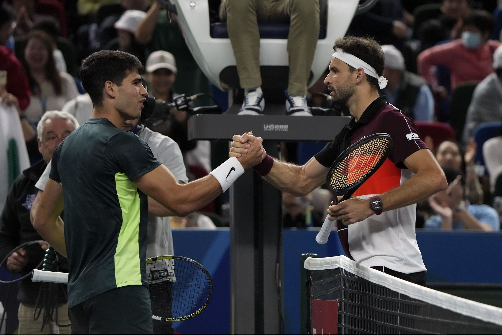 Carlos Alcaraz and Grigor Dimitrov greet each other.