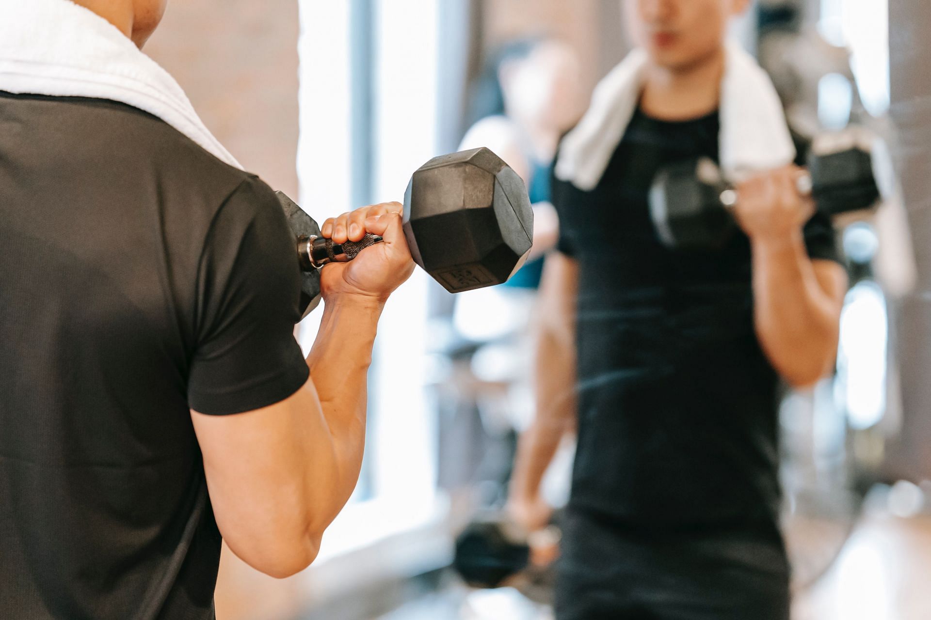 Dumbbell curls. (Image credits: Pexels/ Andres Ayton)