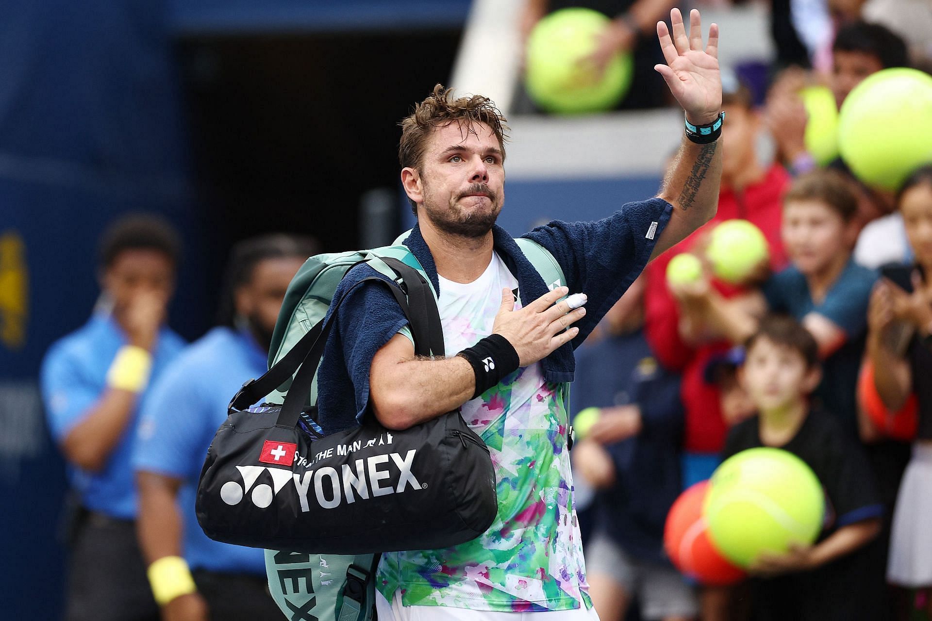Stan Wawrinka waves to fans after exiting the 2023 US Open