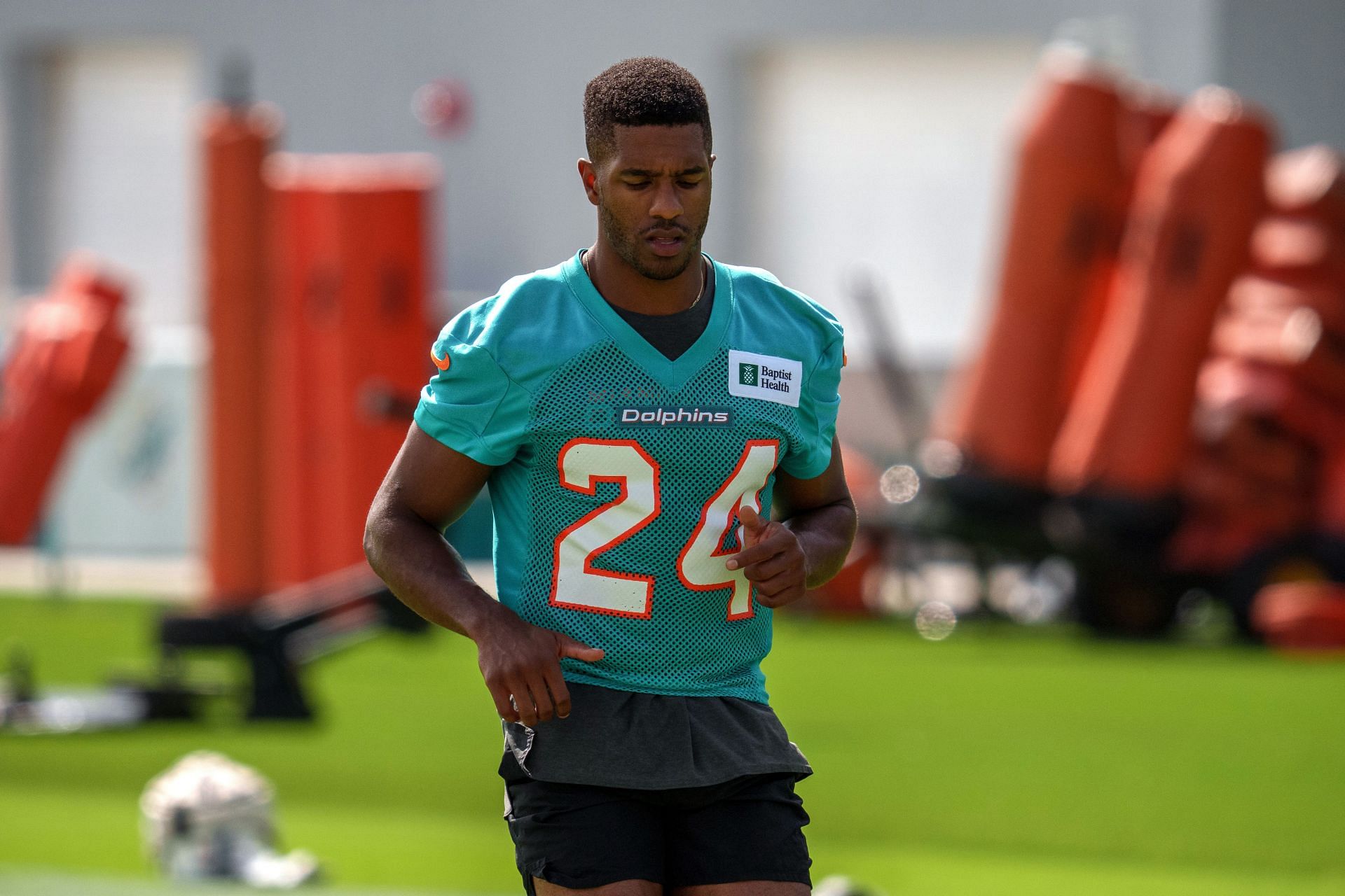 Cornerback Byron Jones #24 of the Miami Dolphins warms up prior to practice drills during Training Camp at Baptist Health Training Complex on July 30, 2021, in Miami Gardens, Florida.