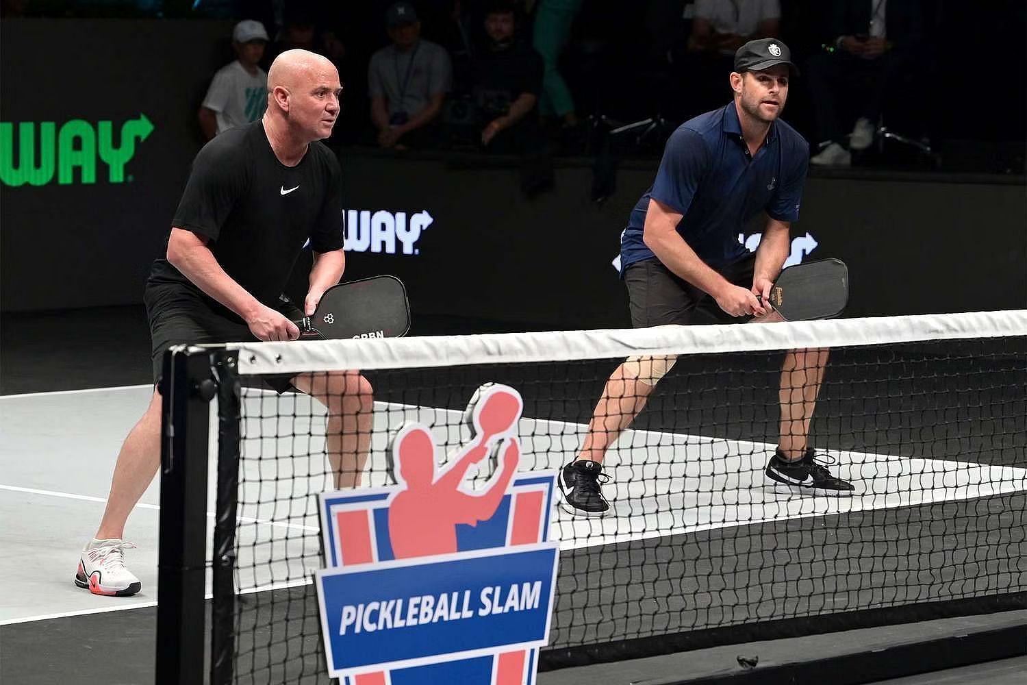 Andre Agassi and Andy Roddick in action at a Pickleball exhibition match