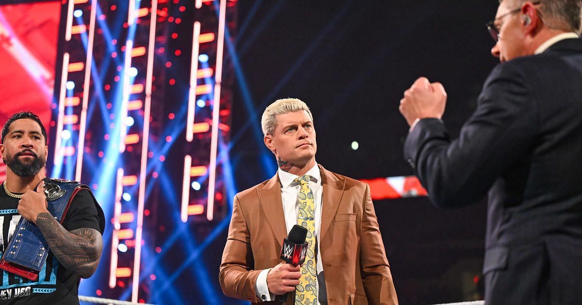 Jey Uso, Cody Rhodes, and Michael Cole.
