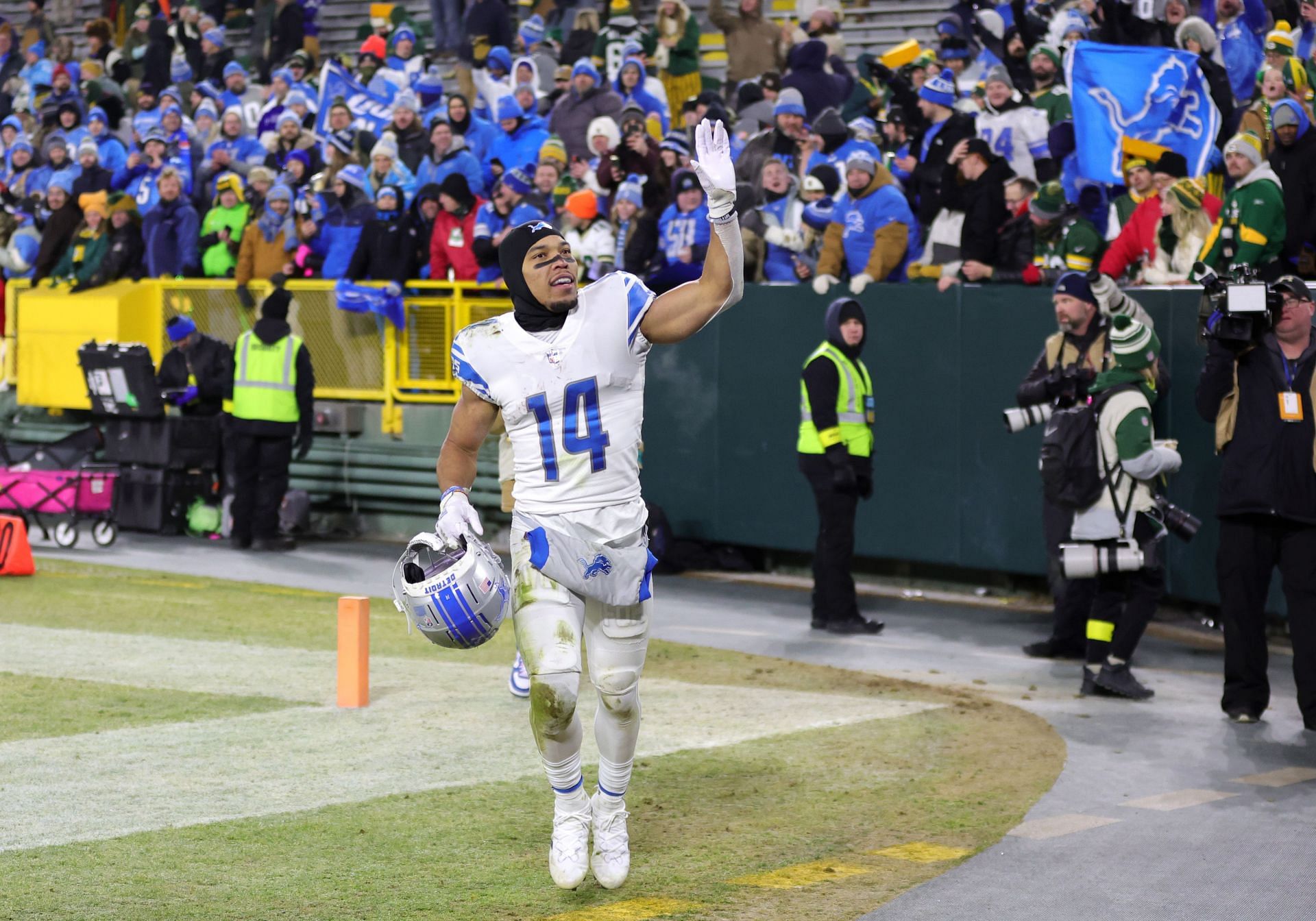 Detroit Lions wide receiver Amon-Ra St. Brown waves to the fans at Lambeau Field.