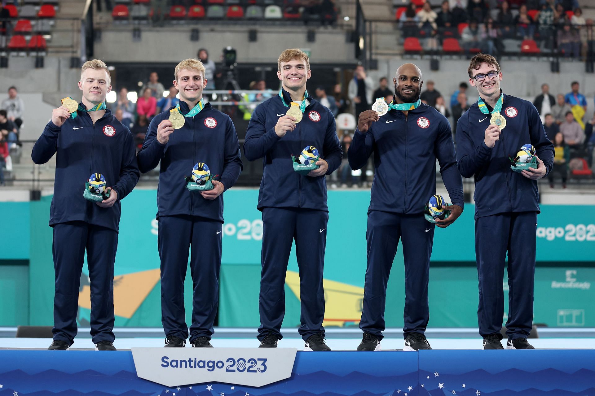 Cameron Bock, Colt Walker, Curran Phillips, Donnell Whittenburg, and Stephen Nedoroscik of Team USA pose on the podium after winning the gold medal in the Men's Team Final at the 2023 Pan American Games in Santiago, Chile.