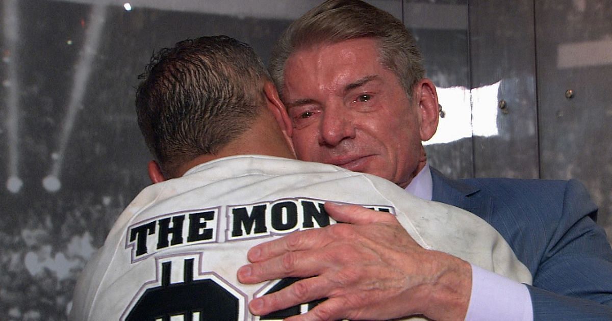 Vince and Shane McMahon sharing an emotional hug backstage.