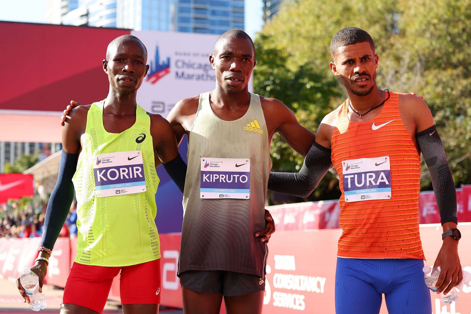 Third-place finisher John Korir of Kenya, first-place finisher Benson Kipruto of Kenya, and second-place finisher Seifu Tura Abdiwak of Ethiopia pose for a photo after the 2022 Chicago Marathon at Grant Park in Chicago, Illinois