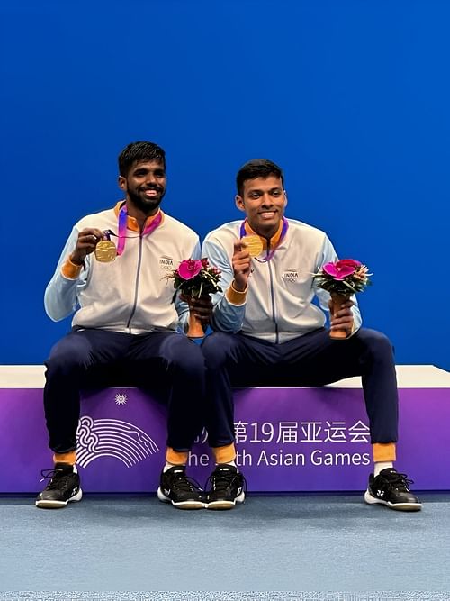 Satwiksairaj Rankireddy (L) & Chirag Shetty celebrate their Asian Games gold medal win. (Image courtesy: Badminton Association of India)