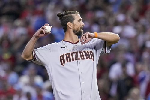 Michael Phelps throws out the ceremonial first pitch before Game 5 of the baseball NL Championship Series between the Philadelphia Phillies and the Arizona Diamondbacks in Phoenix