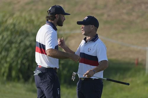 Max Homa, left, and playing partner Brian Harman celebrate on the 17th green after winning their afternoon Fourballs match 2&1 at the 2023 Ryder Cup