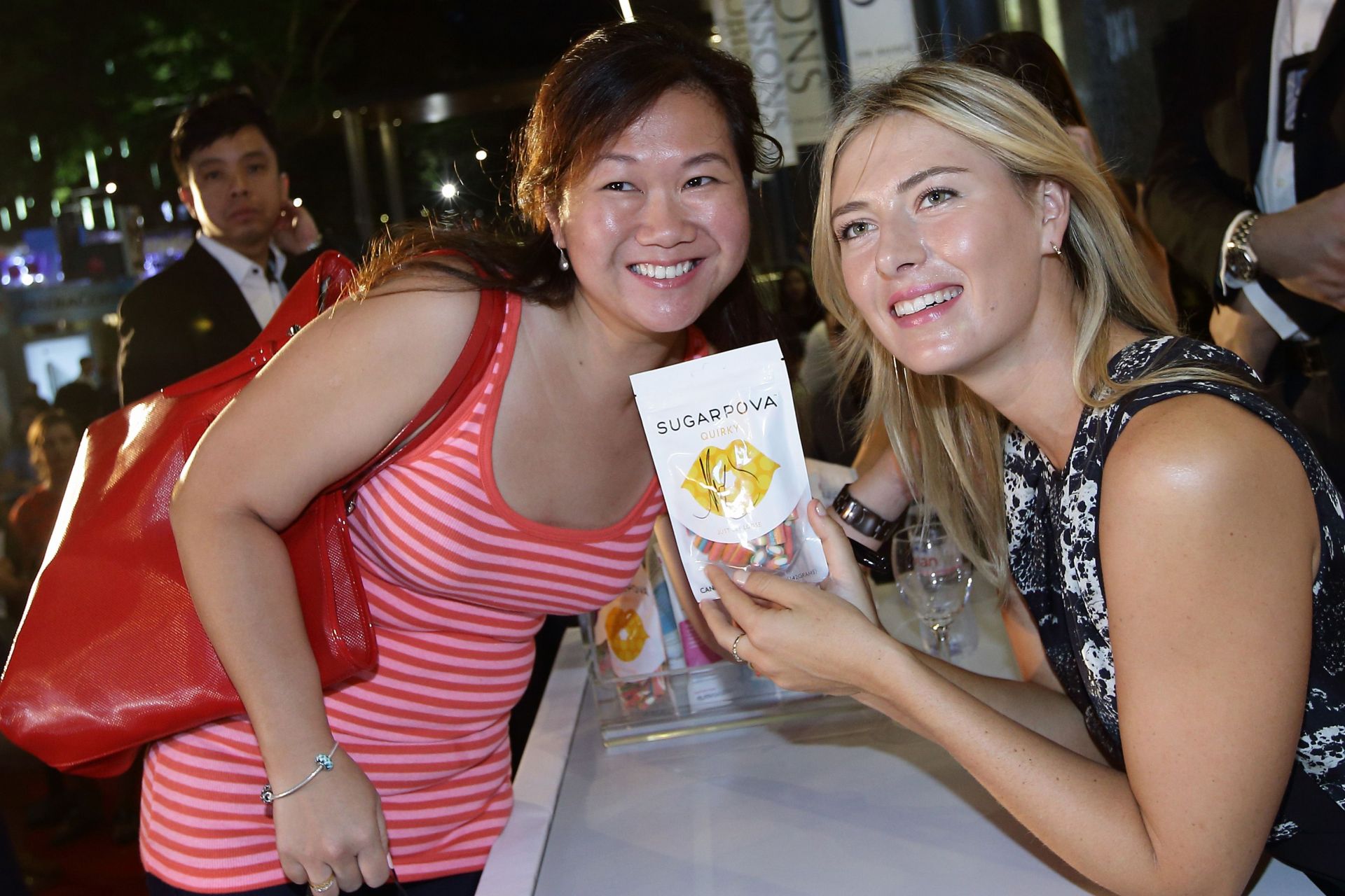 Maria Sharapova with a fan at the launch of 'Sugarpova' Sweets in Singapore.