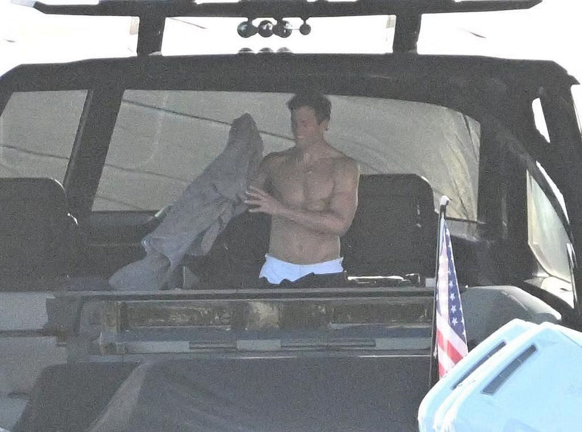 Tom Brady grabbing a towel inside his yacht (via Backgrid for Page Six)