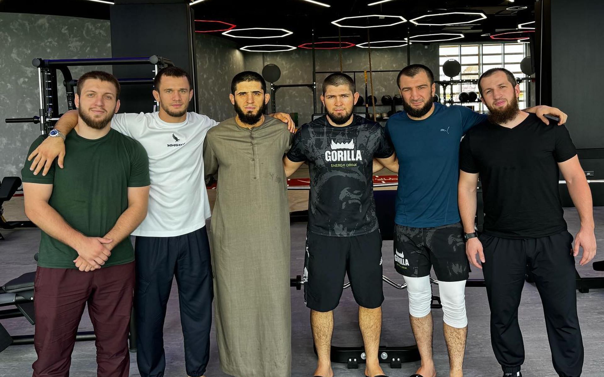 Islam Makhachev and Khabib Nurmagomedov (centre) pose with their teammates [Image Credit: @khabib_nurmagomedov on Instagram]