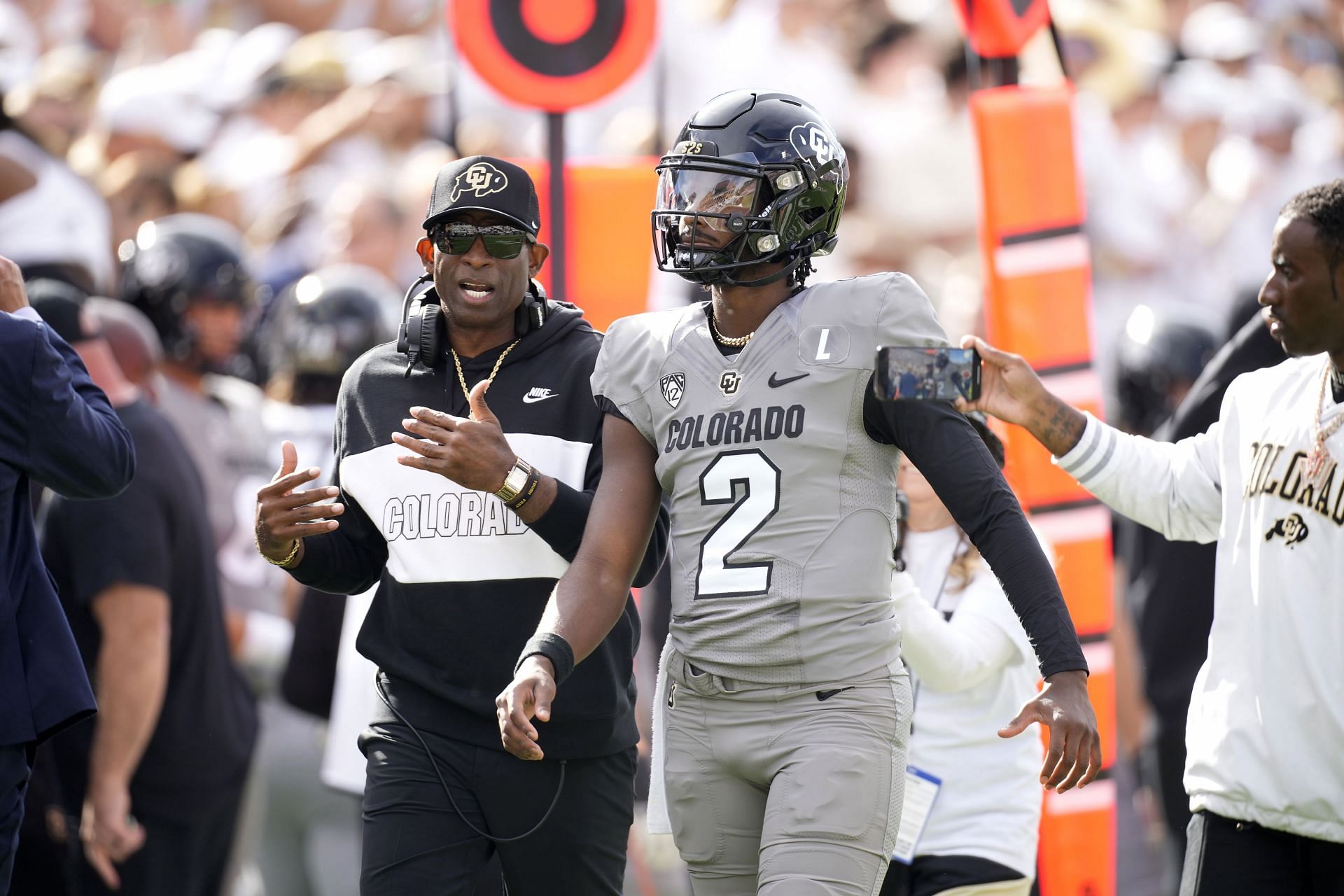 USC Colorado Football: Colorado head coach Deion Sanders, left, talks with his son, quarterback Shedeur Sanders, before the first half of an NCAA college football game against Southern California, Saturday, Sept. 30, 2023, in Boulder, Colo. (AP Photo/David Zalubowski)