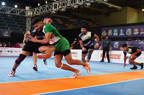 Tamil Thalaivas' K. Prapanjan, in blue and yellow jersey, is pinned down by  players of Patna Pirates during their Vivo Pro Kabaddi league match in  Mumbai, India, Saturday, Aug. 26, 2017. (AP