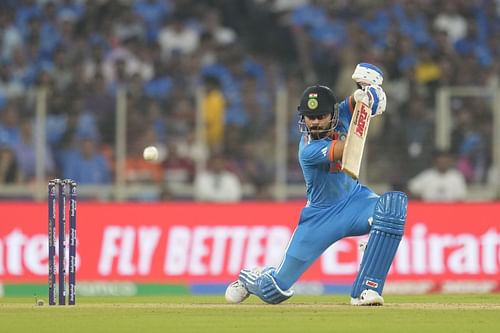 Virat Kohli hits a boundary during the 2023 ICC Men's Cricket World Cup match between India and Pakistan in Ahmedabad, India.